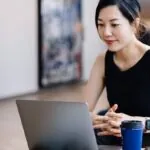 Asian female working on laptop